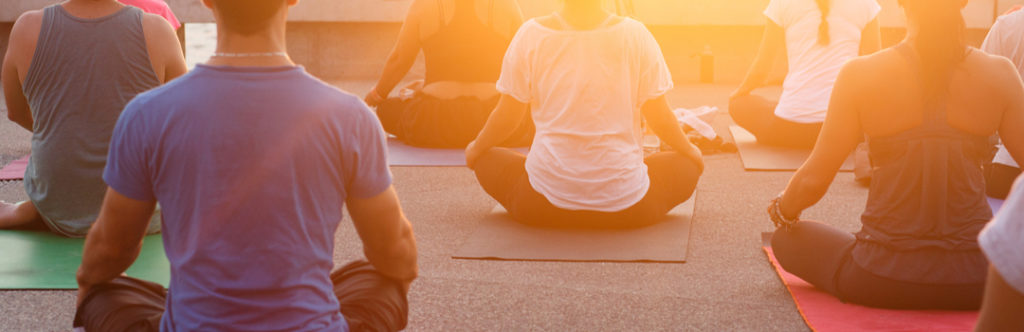 People, who understand the importance of meditation, meditating on a during a sunset