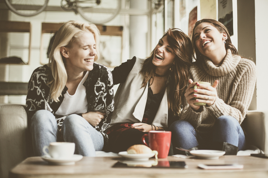 Relationships - three female friends fostering their relationship at a coffee shop